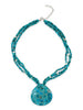 A three-strand turquoise with white pearl accent and a Reversible Turquoise and carved Mother of Pearl Pendant